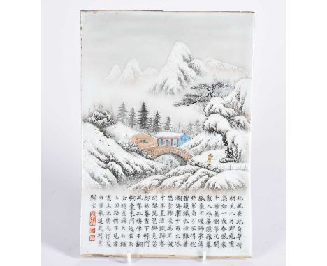 A Chinese porcelain panel, 20th century, painted with a snow scene of a figure approaching a bridge towards dwellings, above 