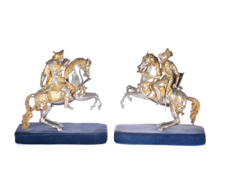 A pair of parcel gilt and silvered metal equestrian warrior figures, 20th century, modelled as a medieval knight with lance a