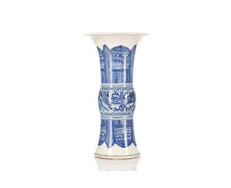 A Chinese blue and white Gu form vase, the centre painted with Taotie masks between leaves and bladed panels with key bands, 