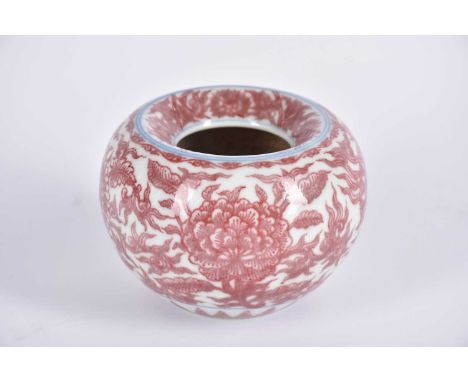 A Chinese iron red brush washer, of bulbous form with inverted rim, painted with peonies and chrysanthemums with stems and le