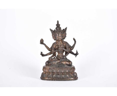 A Chinese bronze figure of the Tibetan deity Usnisavijaya, seated o a double lotus base, traces of red pigment and gilding, 1