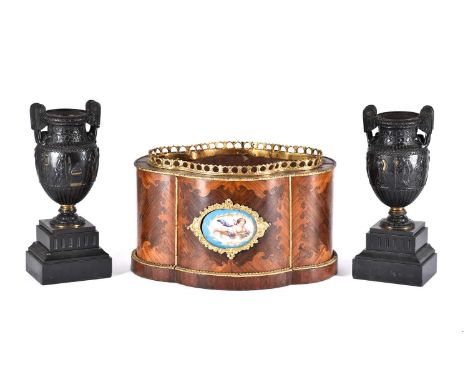 A French kingwood and gilt metal mounted quatreform jardiniere, 19th century, with Paris porcelain plaque painted with a cher