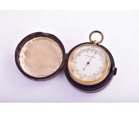 A brass compensated pocket barometer and compass ; silvered circular dial; in original leather-bound wooden case, the reverse