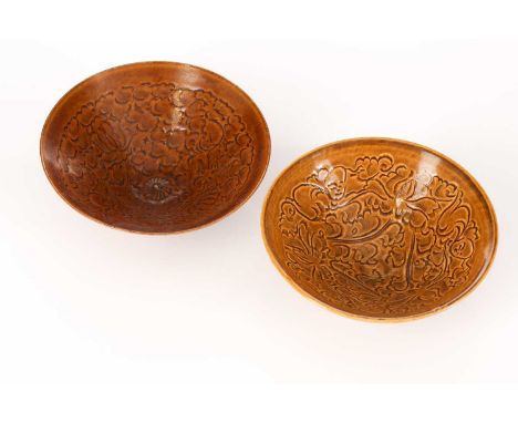 A pair of Chinese Song Dynasty style bowls, of circular tapering form, each with incised decoration of boys amongst foliage a