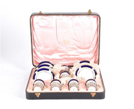 An early 20th Century set of six Copeland Spode coffee cans and saucers with hallmarked silver holders with cherubs, holders 