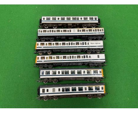 Two 00 gauge three-car Diesel Multiple units by Hornby and Lima in BR White and Blue Stripe livery, both untested.