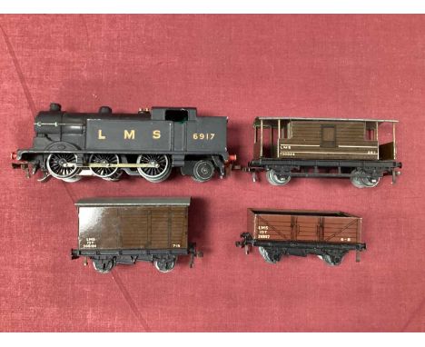 An Immediate Post War Hornby Dublo Three Rail 0-6-2 N2 Tank, in LMS finish with three LMS wagons, all very good, untested.