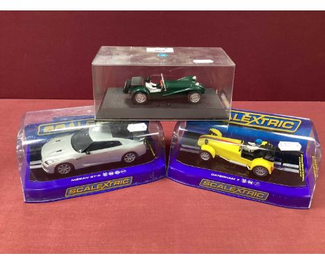 Three Scalextric 1:32 Scale Slot Cars comprising of #C2991 Nissan GT-R Silver, #C3425 Caterham 7, Lotus 7, cased.