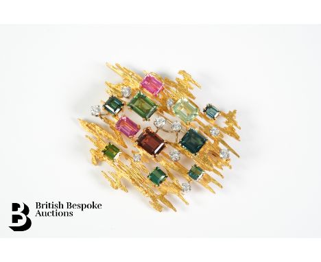 18ct yellow gold Swiss modernist brooch. The brooch set with ten brilliant cut satellite diamonds 1ct and 7 carats of green, 