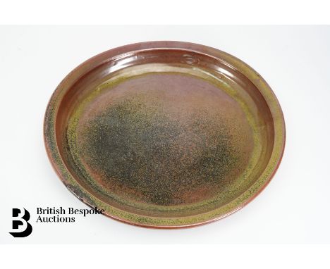 Ray Finch (British, 1914-2012) for Winchcombe Pottery dish with a raised rim, iron rich glaze, approx 40 cms diameter, rust g