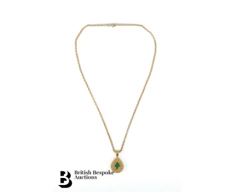 18ct yellow gold emerald and diamond pendant. The tear-shaped emerald measures 8 x 6mm, 75 pts of pave set dias. The pendant 