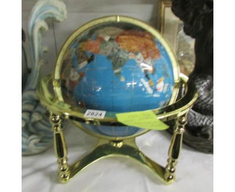 A large gem set table globe on brass base.