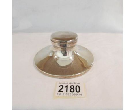 A silver inkwell.