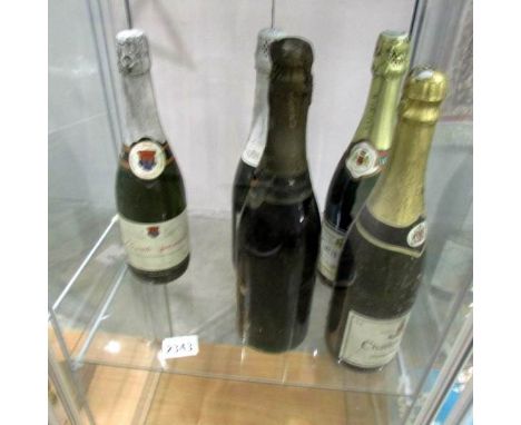 3 old bottles of unopened sparkling wine.