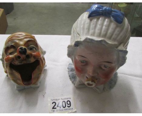A ceramic tobacco jar in the form of a babies head and a novelty ash tray.