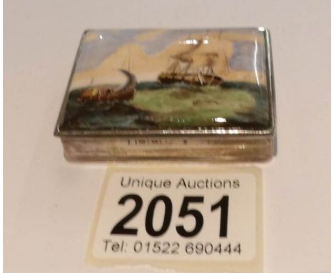 A silver snuff box with enamel lid depicting seascape.