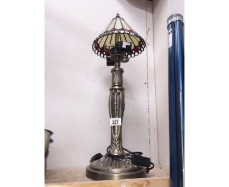 A Tiffany style table lamp with spelter base.