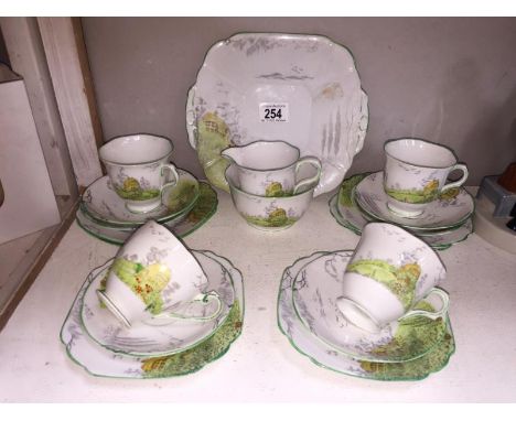 A Melba china tea set with cottage scene