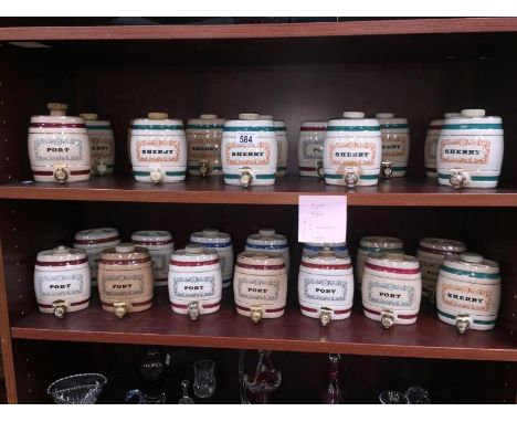 2 shelves of various ceramic alcohol kegs