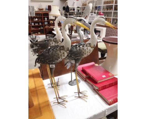 3 metal and 1 plastic stork ornaments (some light up)