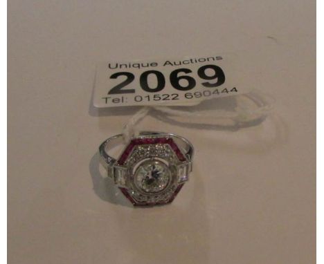 An 18ct white fold fine quality ruby and diamond octagonal art deco style cluster ring, centre diamond weight 0.77 carat.  Si
