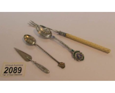 A silver pickle fork, 2 silver spoons and a silver book mark.