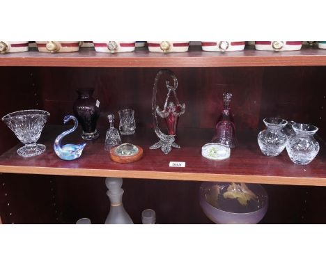 A shelf of glassware including paperweights, vases etc.