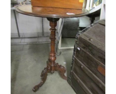 A walnut veneer tripod table (some veneer lifting).