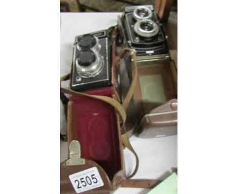 A cased Ricohmatic 225 camera and a cased Photina reflex camera, untested.