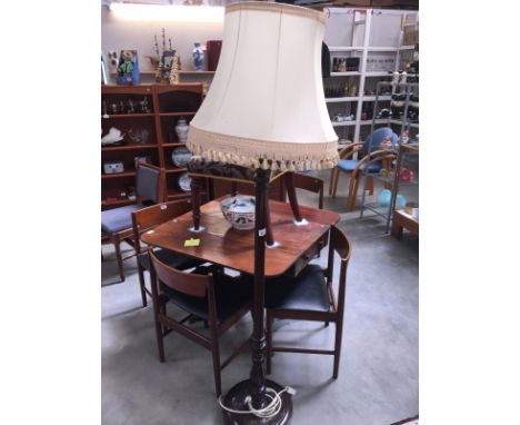 A darkwood stained standard lamp