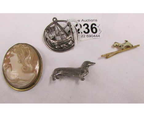 A silver dachsund dog brooch, an enamel dog brooch and 2 other brooches.