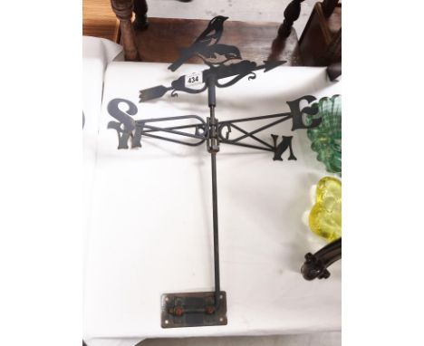 A wrought iron weather vane