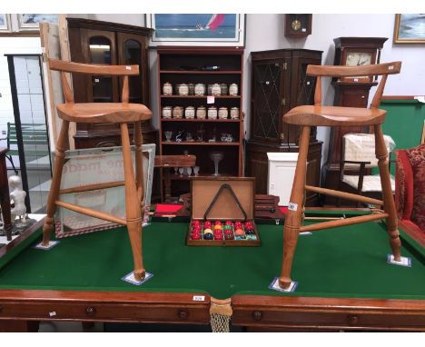 A pair of light wood kitchen/bar stools