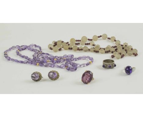 A ROCK CRYSTAL AND GARNET BEAD NECKLACE, and an amethyst and gold bead necklace, three rings and a pair of amethyst earrings.