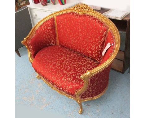 SOFA, two seater, Louis XV style, in red floral fabric on a gilded frame, 133cm L.