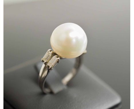 A SOUTHSEA CULTURED PEARL AND BAGUETTE DIAMOND DRESS RING, mounted in 18 carat white gold French control marks size M.