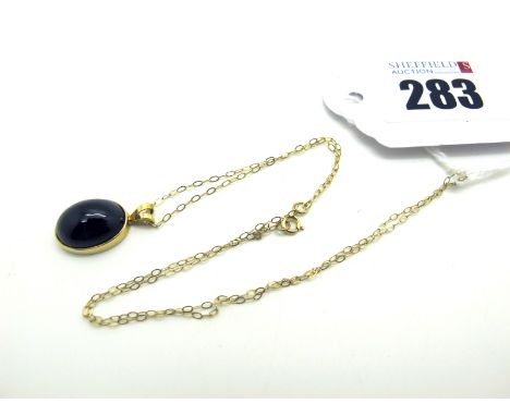 A 9ct Gold Cabochon Garnet Pendant, oval collet set, on  fine chain. [802509]