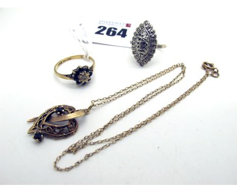 A Modern 9ct Gold Pendant, of pierced design with claw set highlights, on a chain; together with a vintage marcasite set dres