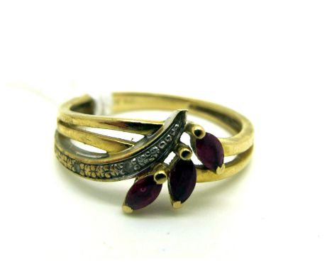 A Modern Ruby and Diamond Set Dress Ring, of abstract design, illusion and claw set, stamped "Dia" "375" (finger size J) (1.5
