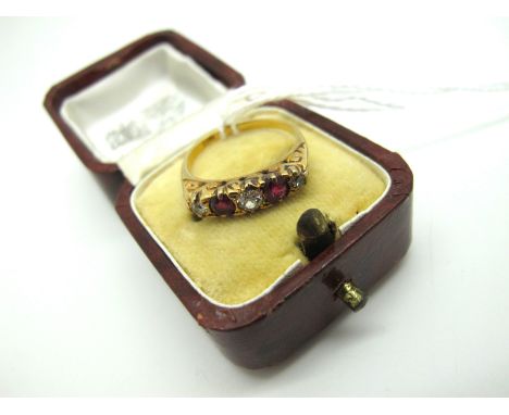 An Antique Ruby and Diamond Five Stone Ring, alternately set within scroll carved setting, stamped "18ct" (figer size N) (4.2