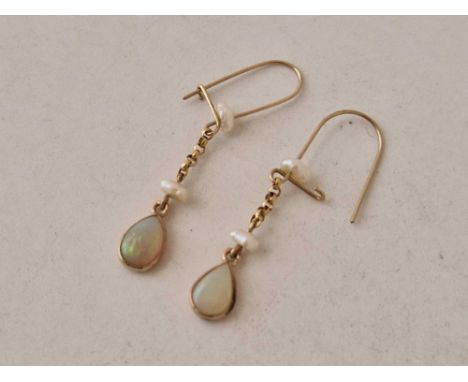 A pair of gold and opal drop earrings