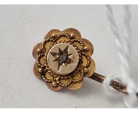 A diamond topped stick pin 9ct