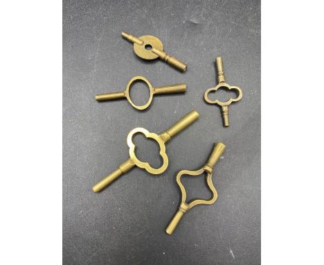 five assorted brass travelling clock keys