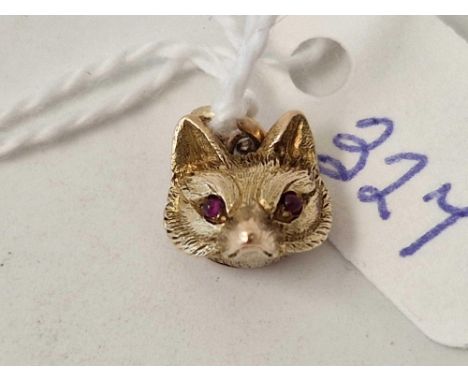 A fox head charm with ruby charms 15ct gold 2.6 gms