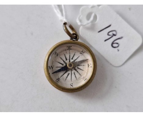 A gold back compass fob