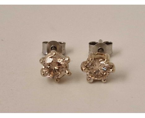 Pair of 18ct and platinum diamond stud earrings weighing a total of 0.95 cts Birmingham 1976, size R,  8.1g