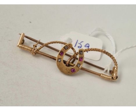 A Victorian gold ruby and diamond riding crop and horse shoe brooch 9ct 6.4 gms