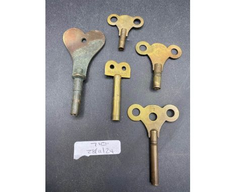 five assorted brass travelling clock keys