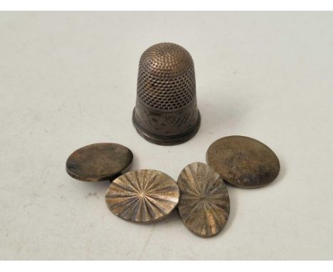 A silver thimble and a pair of cufflinks