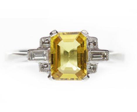 EIGHTEEN CARAT WHITE GOLD YELLOW SAPPHIRE AND DIAMOND RINGset with a central step cut yellow sapphire of 7.6x5.6mm flanked by